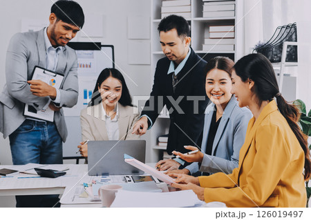 Team of financial advisory services. Asian advisor showing plan of investment to clients in the consultancy office. 126019497