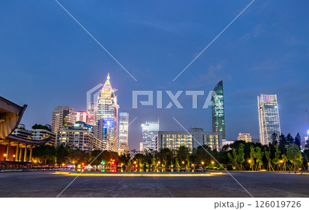The modern skyline of Taipei, Taiwan, glows at dusk with illuminated skyscrapers rising above Zhongshan Park, showcasing a vibrant blend of urban architecture and evening serenity. 126019726
