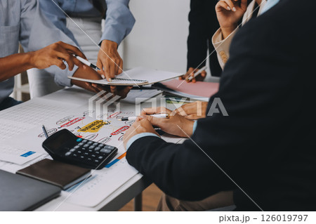 Team of financial advisory services. Asian advisor showing plan of investment to clients in the consultancy office. Team of financial advisory services. Asian advisor showing plan of investment to clients in the consultancy office. 126019797