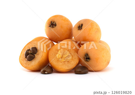 A delightful pile of fresh, ripe loquats, showing both whole and cut sections. A delightful pile of fresh, ripe loquats, showing both whole and cut sections. 126019820
