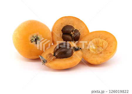A close-up of fresh loquats, with some cut open to reveal their seeds and soft texture. A close-up of fresh loquats, with some cut open to reveal their seeds and soft texture. 126019822