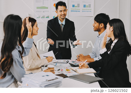 Team of financial advisory services. Asian advisor showing plan of investment to clients in the consultancy office. 126021502