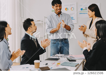 Team of financial advisory services. Asian advisor showing plan of investment to clients in the consultancy office. 126021506