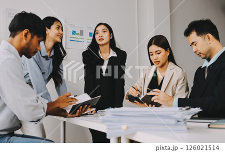 Team of financial advisory services. Asian advisor showing plan of investment to clients in the consultancy office. 126021514