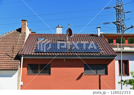 Family house with solar panels on the roof. Home photovoltaic power plant. Concept for industry and green cheaper electricity from renewable sources. 126022353