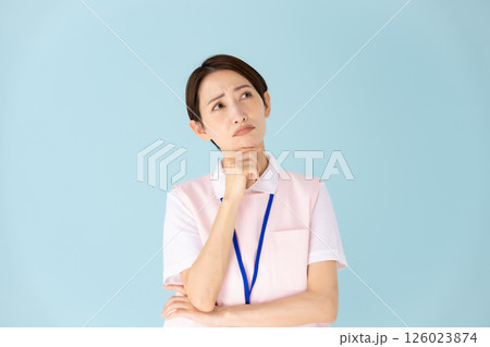 エプロンの女性　介護士　保育士　医療　悩む 126023874