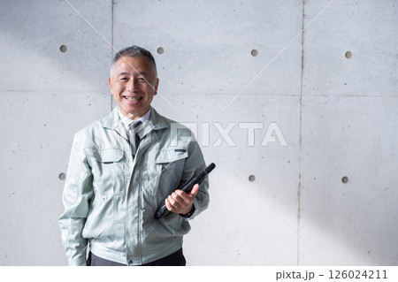 建築現場を支えるベテラン男性の堂々とした立ち姿 建築現場を支えるベテラン男性の堂々とした立ち姿 126024211