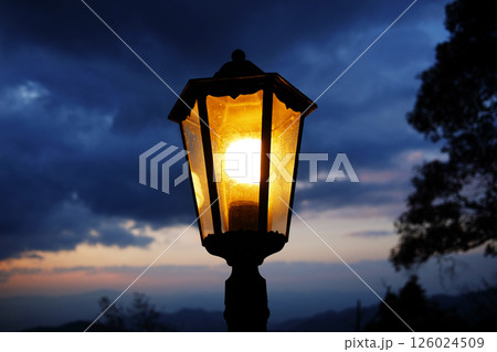 Classic and vintage black iron street light in strom and dark cloud sky with twilight in the evening night 126024509