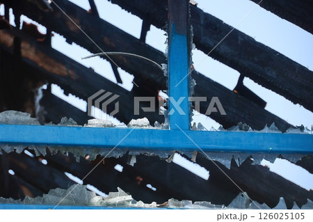 A blue roof with black shingles and a hole in it 126025105