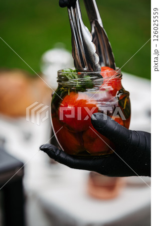 Jar with grilled tomatoes in oil. 126025559