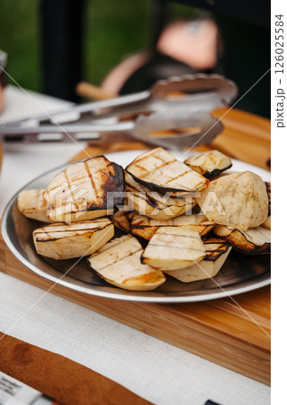 Grilled apple slices with char marks on serving plate. 126025584