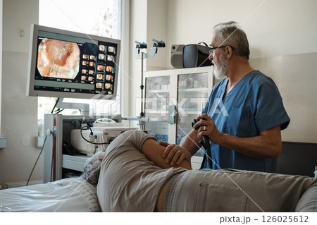 Gastroscopy procedure on sedated patient to examine upper digestive tract. 126025612