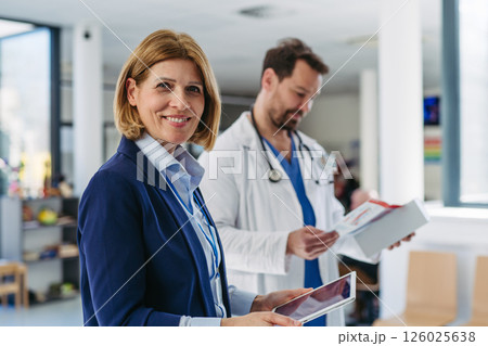 Pharmaceutical rep meeting with healthcare professional to discuss new drugs Pharmaceutical rep meeting with healthcare professional to discuss new drugs 126025638