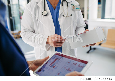 Business interaction between pharma rep and healthcare provider. 126025643