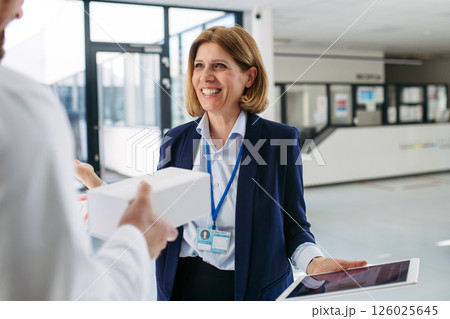 Female medical sales representative presenting medication to doctor 126025645