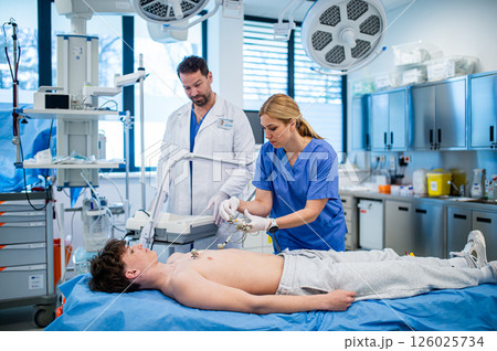 Preoperative EKG examination of teenage patient in hospital setting. Preoperative EKG examination of teenage patient in hospital setting. 126025734