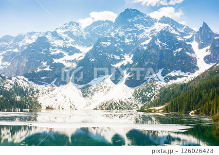 landscape with lake in tatra mountains of poland in spring. beautiful travel destination of europe. outdoor adventure and vacation season on morskie oko landscape with lake in tatra mountains of poland in spring. beautiful travel destination of europe. outdoor adventure and vacation season on morskie oko 126026428
