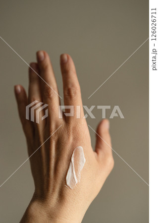 Female hand with moisturizing cream. Female hand with moisturizing cream. 126026711