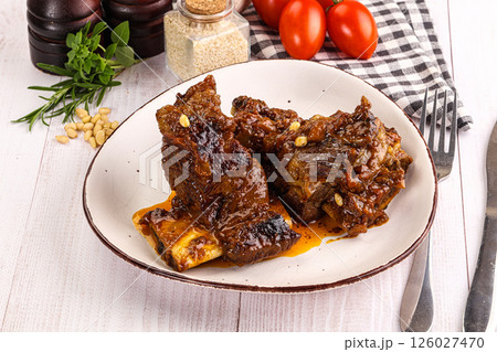 Prepared tasty beef ribs with sauce 126027470