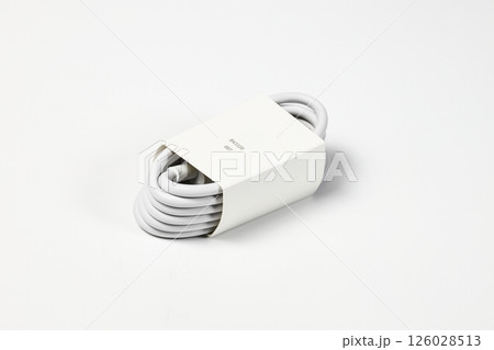 New white USB type charger cable, compatible for many devices, wrapped in a spiral shape, isolated on white background. New white USB type charger cable, compatible for many devices, wrapped in a spiral shape, isolated on white background. 126028513