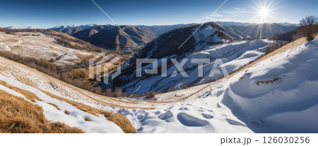 Vast Snowy Mountain Valley Landscape Under a Bright Sun 126030256