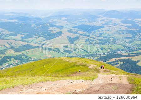 scenery with hiking path in summer. distant horizon. beautiful mountain landscape with green hills and steep slopes. trail through borzhava ridge. view in to the valley. spectacular highland of scenery with hiking path in summer. distant horizon. beautiful mountain landscape with green hills and steep slopes. trail through borzhava ridge. view in to the valley. spectacular highland of 126030964