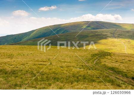 green mountain landscape with trail for hiking. vacation season. path through nature hill to the top for outdoor travel and beautiful view. alpine tourism scenery in summer with sky and cloud 126030966
