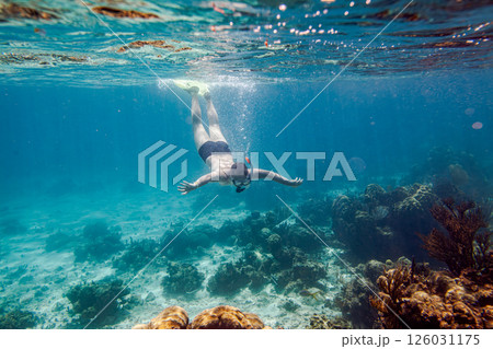 Snorkeling and skin diving on the coral reef edge in tropical waters... 126031175