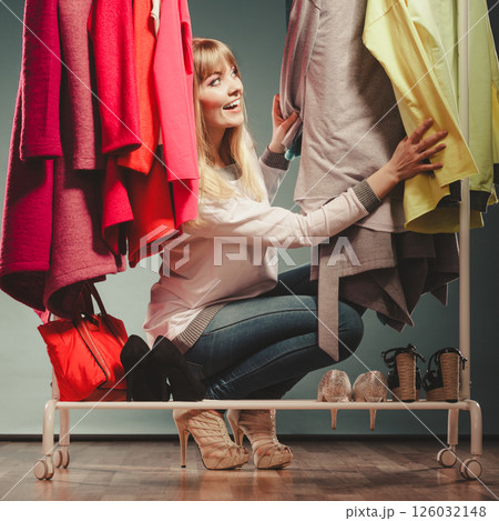 Woman choosing clothes to wear in mall or wardrobe Woman choosing clothes to wear in mall or wardrobe 126032148