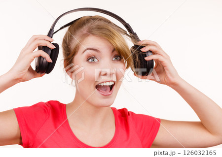 Woman in big headphones listening music isolated Woman in big headphones listening music isolated 126032165