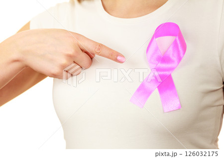 Closeup pink cancer ribbon on woman chest Closeup pink cancer ribbon on woman chest 126032175