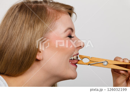 Blonde woman having tongue in clothespin 126032199