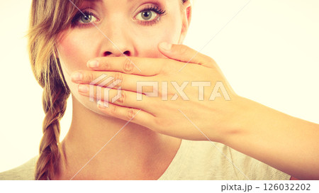 Sad woman covering mouth with hand Sad woman covering mouth with hand 126032202