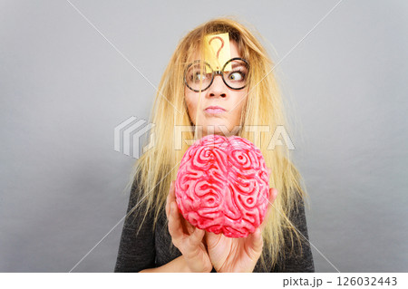 Weird woman holding brain having idea 126032443