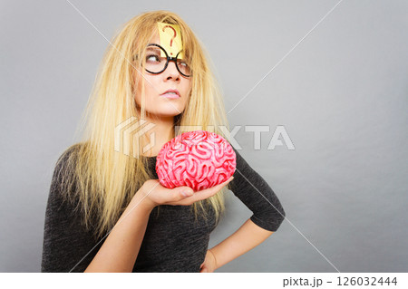 Weird woman holding brain having idea Weird woman holding brain having idea 126032444