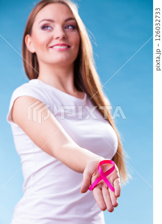 Woman with breast cancer awareness ribbon on hands Woman with breast cancer awareness ribbon on hands 126032733