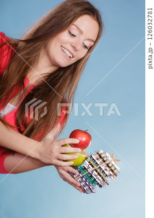 Woman holding pills and fruits. Health care Woman holding pills and fruits. Health care 126032781
