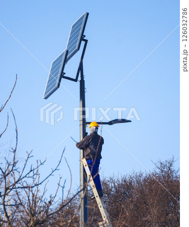 Male engineer at work place, solar collector Male engineer at work place, solar collector 126032786