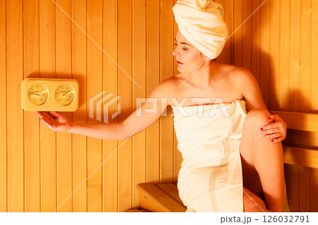 woman relaxing in wooden sauna room woman relaxing in wooden sauna room 126032791