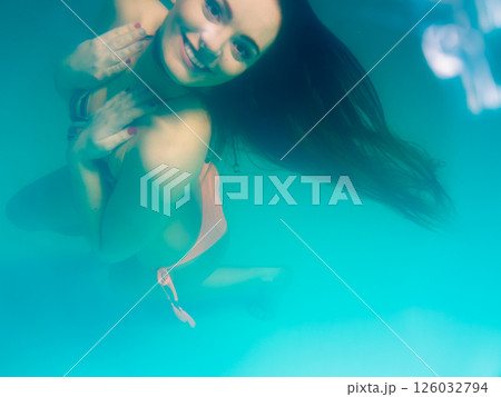 Underwater girl wearing bikini in swimming pool 126032794