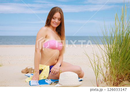 Woman resting on beach. 126033147