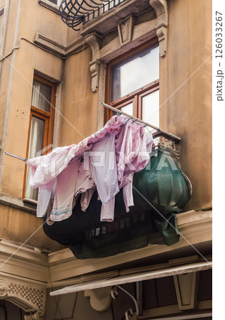 Clothes drying on balcony of vintage building showcasing unique architectural features. High quality photo 126033267