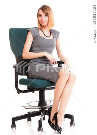 Full length business woman sitting on chair holding clipboard isolated 126033328