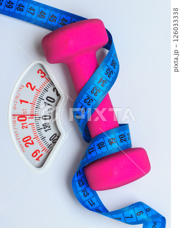 Dumbbell measuring tape on weight scale. Fitness 126033338