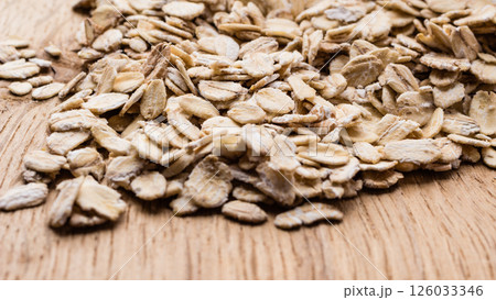 oat flakes cereal on wooden table. 126033346