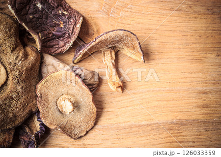 Dry mushrooms on wooden rustic table. 126033359