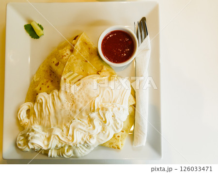 Pancake with wipped cream and strawberry sauce Pancake with wipped cream and strawberry sauce 126033471