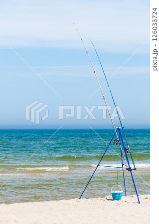 Fishing rod left alone on sea shore Fishing rod left alone on sea shore 126033724