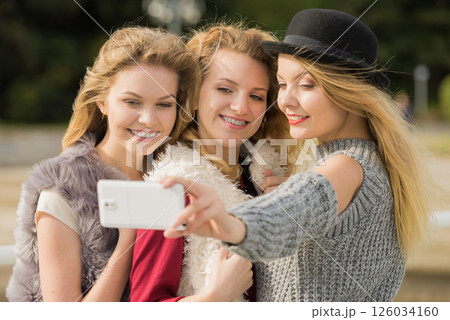 Three women taking selfie outdoor 126034160