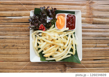 French fries or fried potato , fries with keychup and cheese dip 126034609